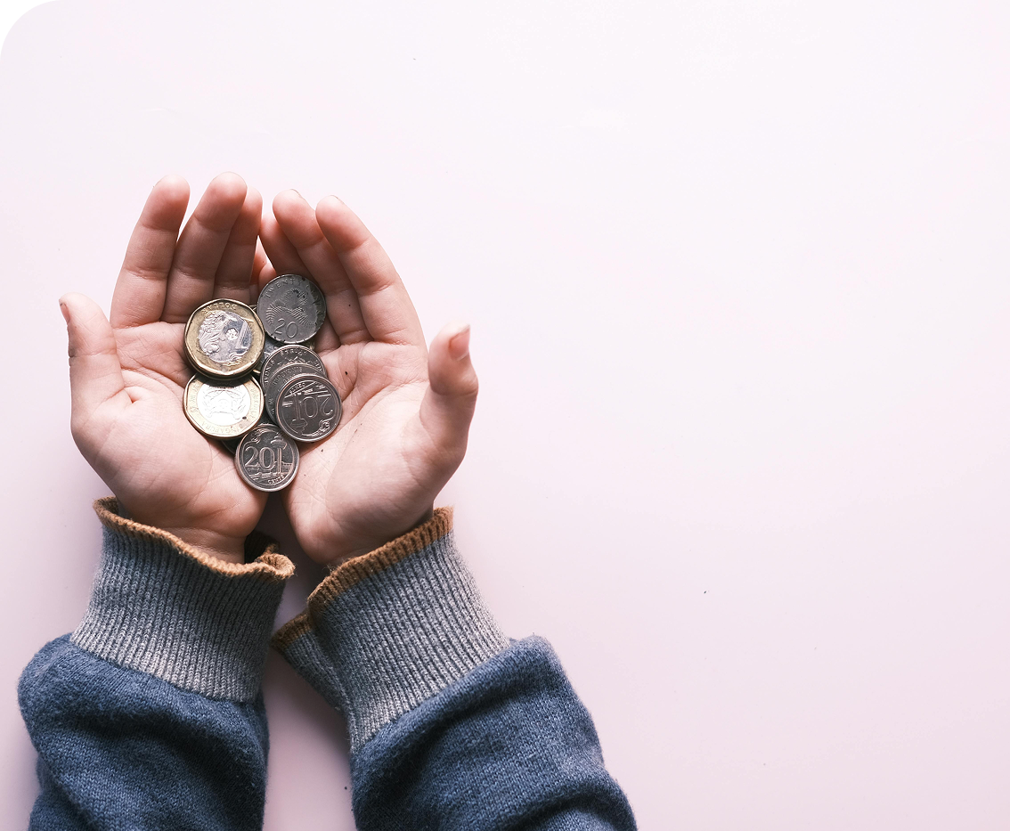 Hands holding coins representing stablecoins